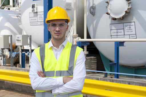 Engineer wearing a hard hat in front of an insallation